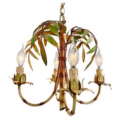 a bamboo chandelier with three lights hanging from it's center and leaves on the bottom