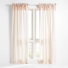 an open window with white curtains and pink drapes