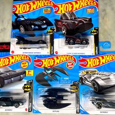 four hot wheels batman cars are on display