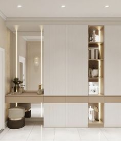 a bathroom with white tile floors and gold trim on the walls, along with shelves