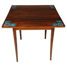 a wooden table with blue and white tiles on the top, against a white background