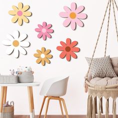 a room with flowers on the wall and a hammock chair