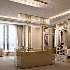 an elegant dressing room with mirrored walls and chandelier hanging from the ceiling above it