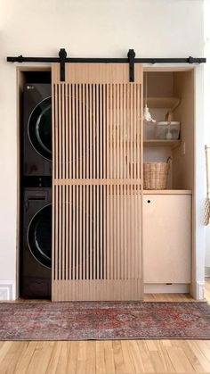 a washer and dryer sitting in a room next to each other on top of a rug