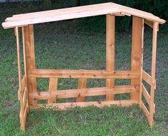 a wooden bench sitting on top of a lush green field