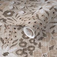 a close up view of a wallpaper with flowers and leaves on the fabric background