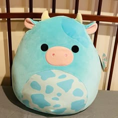 a blue cow pillow sitting on top of a table