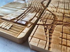 several wooden coasters that have been carved to look like city streets