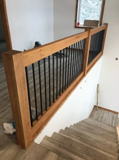 an empty room with wood flooring and railings on the side of the wall