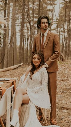 a man in a suit and tie standing next to a woman sitting on a chair