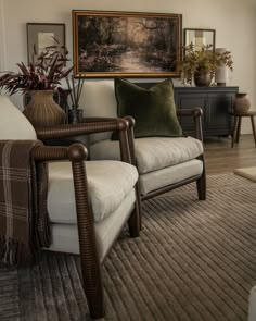 a living room filled with furniture and a painting on the wall above it's headboard