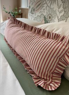 a striped pillow on top of a bed