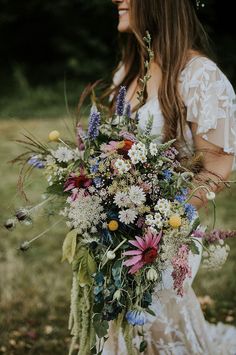 a woman holding a bouquet of flowers in her hands