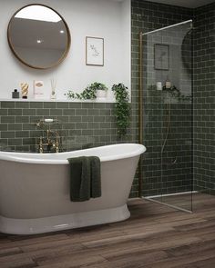 a white bath tub sitting next to a walk in shower under a round mirror on the wall