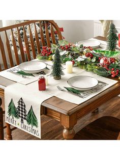 the table is set with christmas decorations and place settings