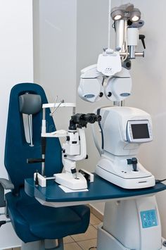 two microscopes sitting on top of a blue table