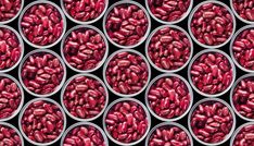 several tins filled with red beans sitting next to each other