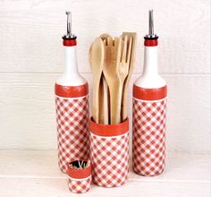 kitchen utensils and wooden spoons in red and white checkered bottles