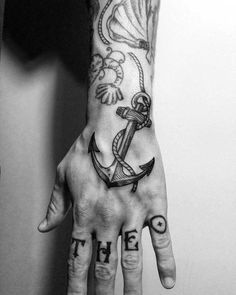 a person's hand with an anchor and the word faith tattooed on it, in black and white