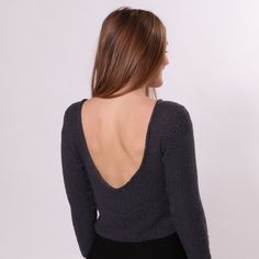 the back of a woman wearing a black sweater