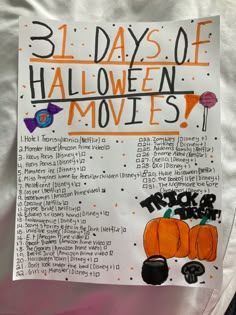 a sign that says 3 days of halloween movies in front of a white sheet with orange and black writing on it