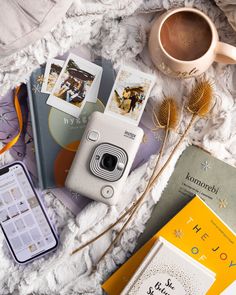 a camera and some books on a blanket