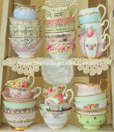 a box filled with lots of different cups and saucers