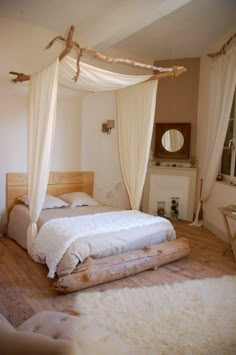 a bedroom with white bedding and curtains