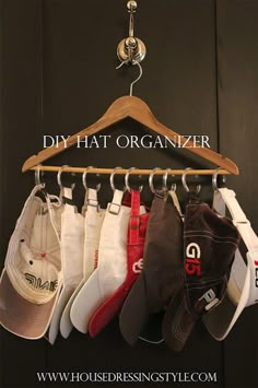 a wooden coat rack with hats hanging from it's hooks and the words diy hat organizer above it