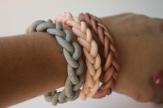 three different colored bracelets on someone's arm