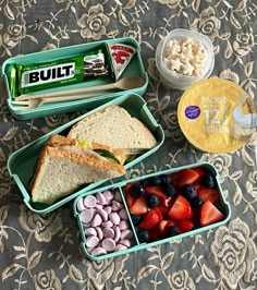 the lunch box is full of different types of food and snacks, including strawberries