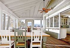 a dining room table with chairs and a ceiling fan