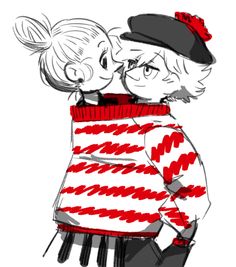 two people in sweaters and hats kissing each other with their noses close to one another