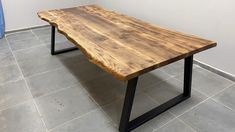 a wooden table sitting on top of a tiled floor