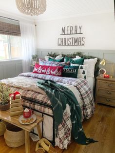 a christmas themed bedroom with plaid bedding and pillows