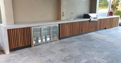 an outdoor kitchen with wood and glass doors