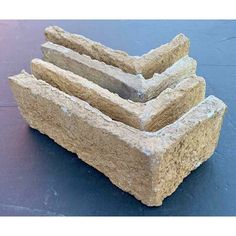 three pieces of stone stacked on top of each other in the shape of rectangles