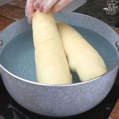 two large long pieces of bread being cooked in a pot