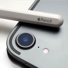 an iphone with a camera attached to it's back end and the front facing up