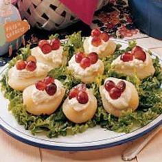 small appetizers are arranged on a plate with lettuce and tomato toppings