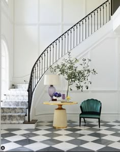 a chair and table in front of a stair case