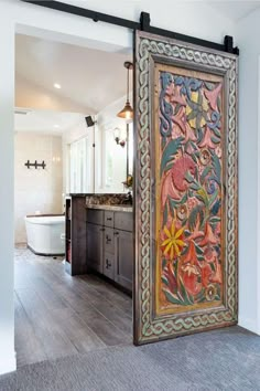 an open door leading to a bathroom with wood floors