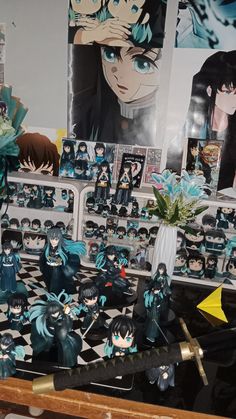 some anime figurines are on display in a room with pictures and other items