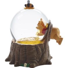 the lion king figurine is in front of a glass ball with water inside