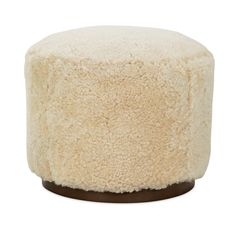 a small stool made out of sheepskin with a wooden base and foot rest in the middle