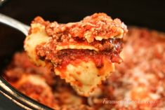 a spoon full of lasagna casserole with meat sauce