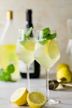 two glasses filled with lemonade and mint