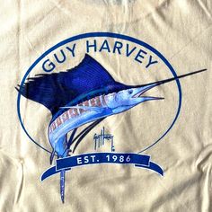 Widely Recognized Today As The World's Finest Marine Artist, Guy Harvey Creates Marine Art With Unmatched Authenticity. You Can See This On The Back Of This Long Sleeve T-Shirt In His Stunning Portrayal Of A Sailfish. Comes In A Cool Pale Yellow Colorway Which Pairs Well With Your Favorite Boardshorts On The Boat Or With Your Perfectly Faded Khaki Shorts Back At The Dockside Bar. 100% Cotton Original Guy Harvey Artwork On The Back Breathable Fabric Machine Washable Tag-Less Label For Comfort Bra Guy Harvey Shirts, Marine Artist, Comfort Bra, Marine Art, Guy Harvey, Steve Mcqueen, Khaki Shorts, The Boat, Pale Yellow