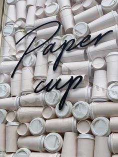 there are many cups stacked up together in the same pattern, with the words paper city written above them