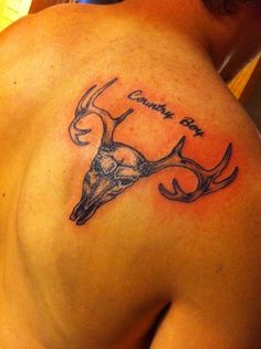 a man with a deer head tattoo on his back